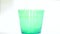 Pure drinking water turn green glass into blue color in white background.