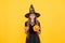 Pure enchantress. jack o lantern. halloween witch girl. happy childhood. teenage child in witch hat. cheerful kid