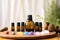 pure essential oils arranged near an aromatherapy diffuser