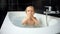 Pure joy of bath time for babies, as a little boy splashes and kicks water, experiencing the wonder of water for the first time