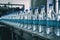 Pure water bottling line in factory, glass bottles on conveyor. Generative AI