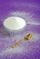 Pure White Granulated Sugar on a Purple Background