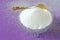 Pure White Granulated Sugar on a Purple Background