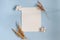 Pure white sheet decorated with dried flowers on a blue background top view