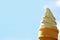 Pure White Vanilla Soft Serve Ice Cream Cone against Sunny Bright Blue Sky, with Free Space for Design