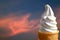 Pure White Vanilla Soft Serve Ice Cream Cone against Sunset Afterglow Cloudy Sky