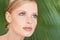 Purely natural. Closeup shot of a beautiful woman against a background of green palm fronds.