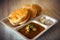 Puri bhaji, close up. Poori masala, fried indian bread. South Indian breakfast Puri with gravy and chutney on wooden table