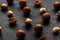 Purified and shell repeats macadamia nuts on black textural stone background. Healthy eating concept