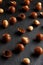 Purified and shell repeats macadamia nuts on black textural stone background. Healthy eating concept