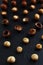 Purified and shell repeats macadamia nuts on black textural stone background. Healthy eating concept