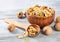 Purified walnuts in a brown wooden bowl