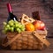 Purim basket with foods and wine on wooden table