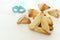 Purim celebration concept & x28;jewish carnival holiday& x29;. Traditional hamantaschen cookies over white wooden table.