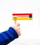 Purim. A child\'s hand holding Colorful wooden noisemaker