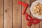 Purim holiday concept celebration with clown mask and hamantaschen cookies on wooden background.