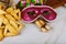 Purim traditional with hamantaschen cookies, noisemaker and carnival mask on wood background