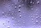 Purple abstract rain drops on the window glass