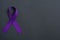 Purple awareness ribbon on black background, space for text