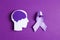 Purple awareness ribbon and brain symbol on a violet background