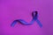 Purple awareness ribbon on color background