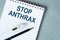 On a purple background a stethoscope with yellow list with text STOP ANTHRAX