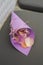 Purple bag with pink rose petals to be sprinkled on newlyweds lay on the chair for wedding ceremony guests. Event decoration with