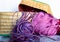 Purple balls wool in wicker basket and pink wool thread