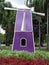 purple bamboo woven wind turbine tower among flower gardens in public park