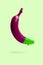 Purple banana with dripping green paint on green background.