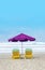 Purple Beach Umbrella With Yellow Lazy Wooden Chair on The Bali Beach During Summer Vacation