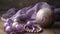 a purple bead necklace and a wooden ball on a table