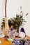 Purple beeswax candle, besom and dried herbs on altar with crystals