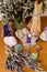 Purple beeswax candle, besom and dried herbs on altar with crystals