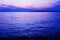 Purple and blue color tone sea water surface and horizon line at the sundown