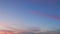 Purple blue pink romantic colorful sky and clouds. Dramatic sky at sunset with puffy clouds lit setting sun. Timelapse.