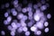 Purple bokeh defocused background. Glitter circular bokeh lights