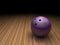 Purple bowling ball in bowling lane