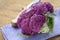 Purple broccoli on a wooden table