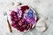Purple Buddha bowl with spiral carrots, cauliflower, beet, onion, potato, shredded red cabbage, radicchio salad, kalamata olives.