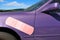 Purple car with a bandaid on side dent