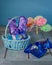 Purple chocolate hares in a wicker basket and colorful balls