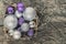 purple Christmas balls and silver, beads lie in a wooden basket