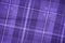 Purple classic checkered table cloth fabric background or texture.