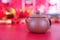 Purple clay milk pot on red background