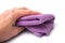 Purple cleaning towel in hand on white background