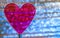 Purple Clear Heart On Coil Spring. Metallic foil background with angled Silver shiny stripes, blue highlights. Valentines Day,