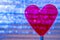 Purple Clear Heart On Coil Spring. Metallic foil background with angled Silver shiny stripes, blue highlights. Valentines Day,