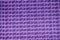 Purple Close up image of black dash mat with grid cells.