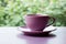 Purple coffee cup rests gracefully on a serene tabletop surface